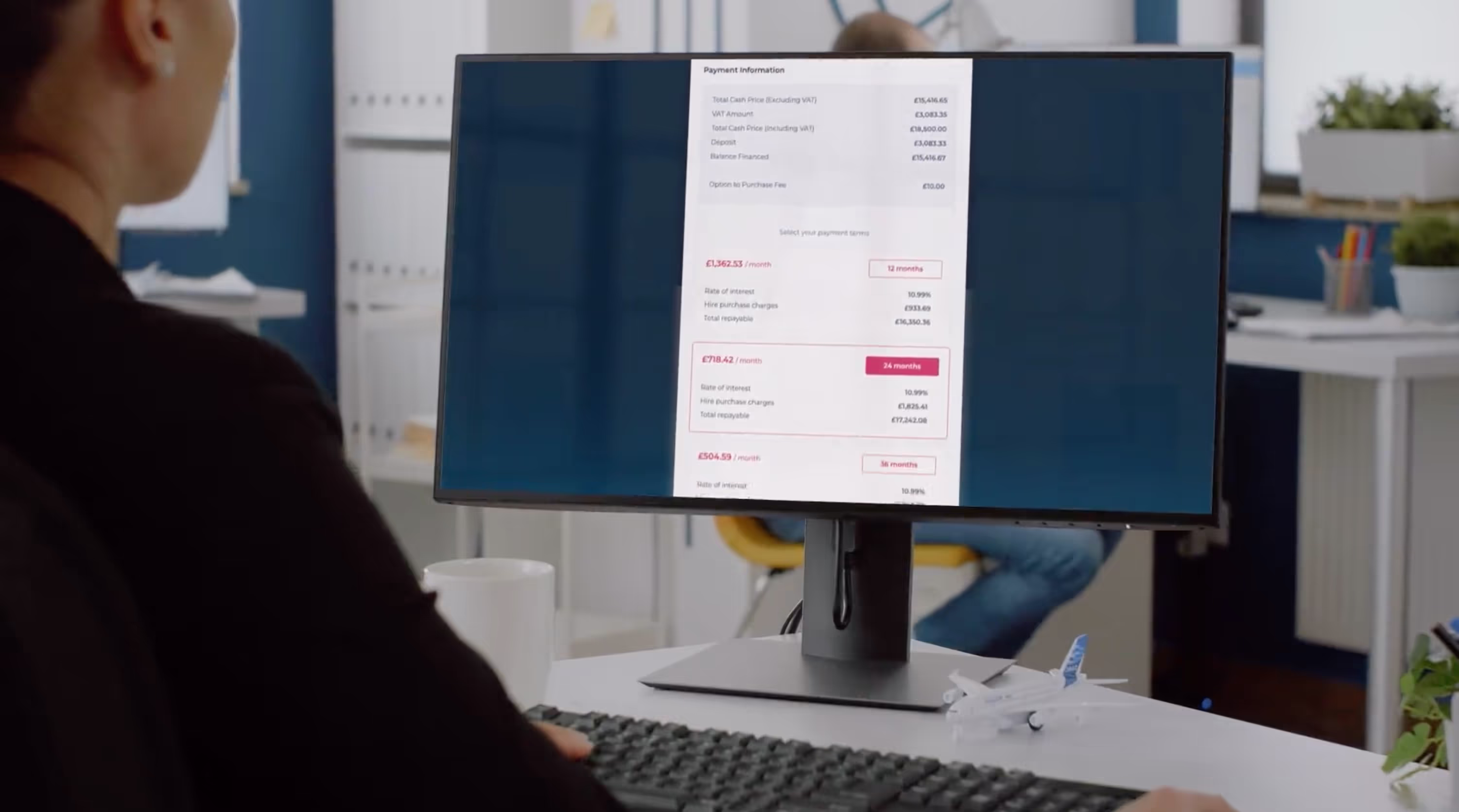 A man is looking into computer screen